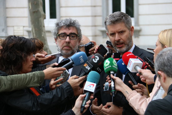 Lawyers representing the Catalan leaders speak outside the Supreme Court in Madrid